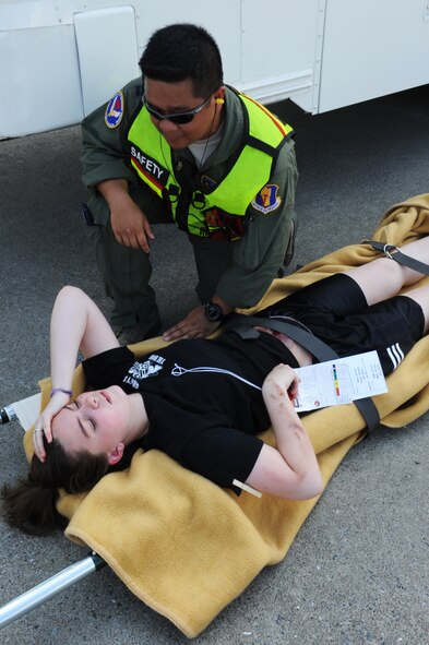 U.S. Air Force Capt. Joseph Teodoro, 35th Aerospace Medicine Squadron aerospace and operational physiologist, talks to a simulated victim during a major accident response exercise at Misawa Air Base, Japan, Aug. 30, 2012. The MARE helps prepare emergency responders for the possibility of a real-world accident during the upcoming Misawa Air Festival. (U.S. Air Force photo/Airman 1st Class Kia Atkins/Released) 
