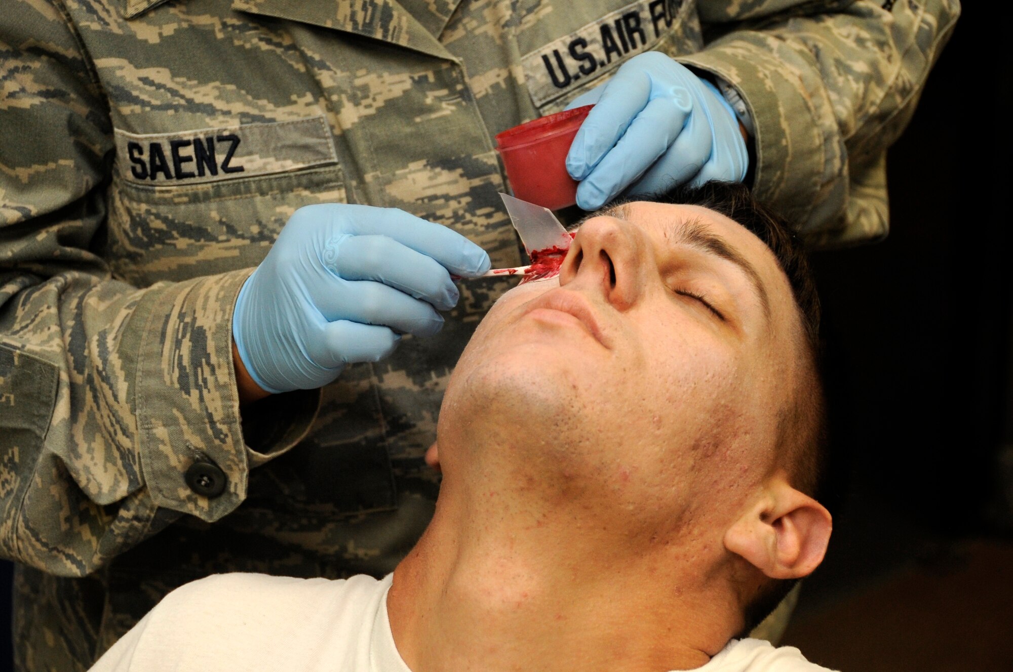 U.S. Air Force Senior Airman Chad Berry, 35th Logistics Readiness Squadron vehicle maintenance journeyman, receives a moulage eye injury at Misawa Air Base, Japan, in preparation for the Major Accident Response Exercise Aug. 30, 2012. The MARE tests the base’s ability to respond to major accidents. (U.S. Air Force photo by Airman 1st Class Kaleb Snay/Released)