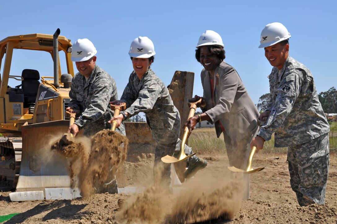 Col. Jed Davis, 30th Mission Support Group commander, Col. Nina Armagno, 30th Space Wing commander, Barbara Bennie, Force Development Flight chief, and Col. Mark Toy, Los Angeles District commander turn over shovels of dirt as part of the official groundbreaking for the Vandenberg Air Force Base education center Aug. 15.  The $14.2 million building will replace a 60-year-old facility that is used by more than 3,000 Airmen and their families.