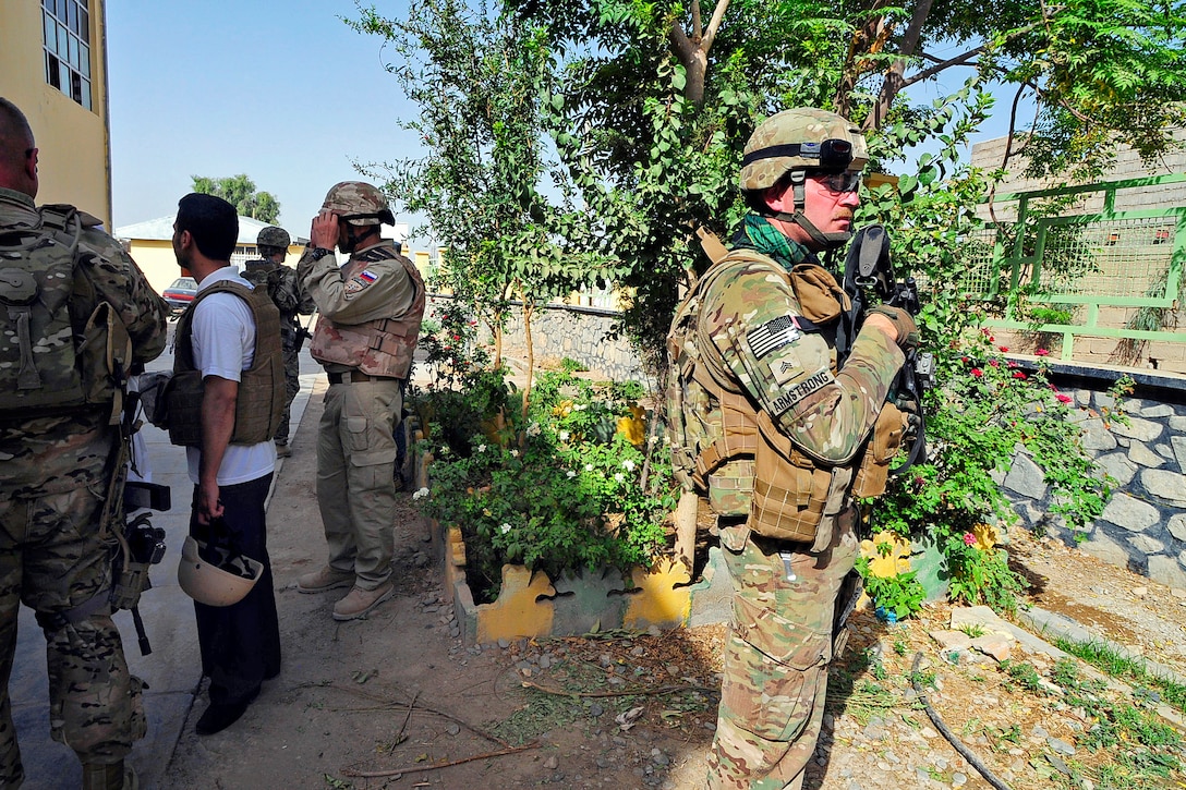 U.S. Army Sgt. Matthew Armstrong, right, provides security during a key leader engagement in Farah City in Afghanistan's Farah province, Aug. 29, 2012. Armstrong is assigned to Provincial Reconstruction Team Farah.