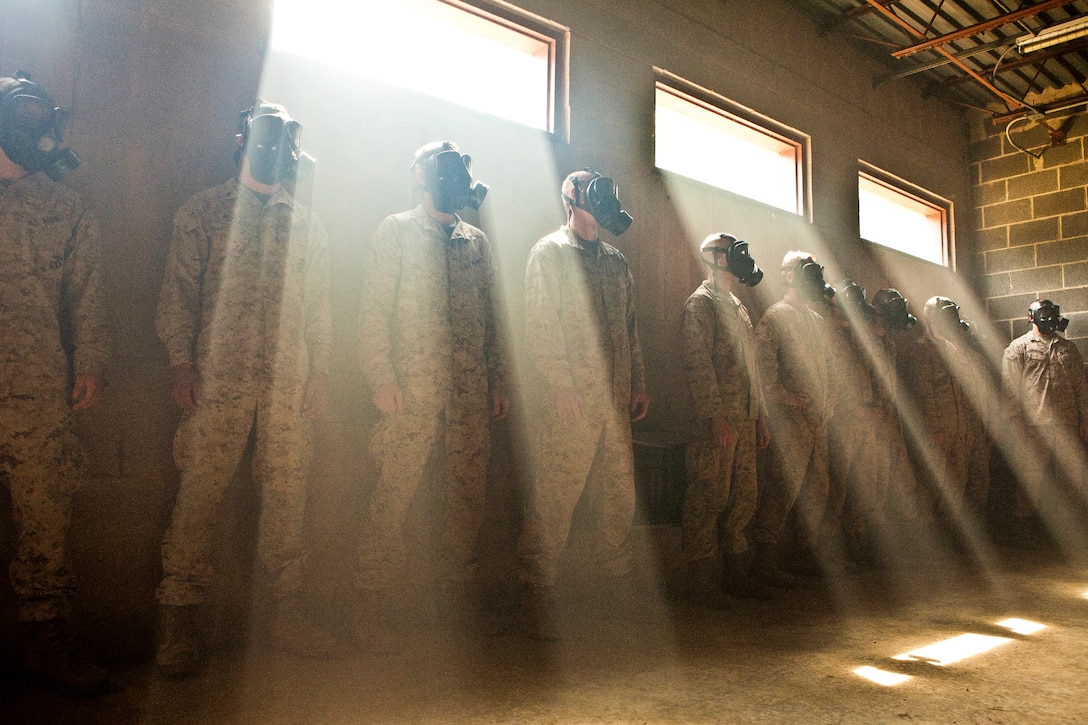 Marines stand against the wall inside a gas chamber during a training exercise on Marine Corps Base Quantico, Va., Aug. 21, 2012. Unit members spent a day at the facility refreshing their knowledge and skills on the M40 gas mask, practice grenades, fragmentation grenades, martial arts and infantryman tactics. The Marines are assigned to Bravo Company, Marine Barracks Washington.