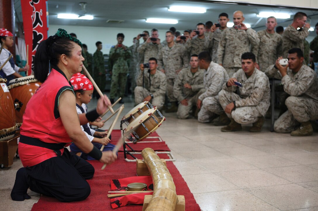 Marines and sailors enjoy a traditional taiko, or drum, performance at Camp Beppu, Japan, Aug. 19. The performance was held during a social engagement designed to strengthen the bond between the Japanese and U.S. service members. The Marines and sailors are with Combat Assault Battalion and 2nd Battalion, 3rd Marine Regiment. Both are with 3rd Marine Division, III Marine Expeditionary Force. 2nd Bn., 3rd Marines, is deployed to Okinawa under the unit deployment program.  
