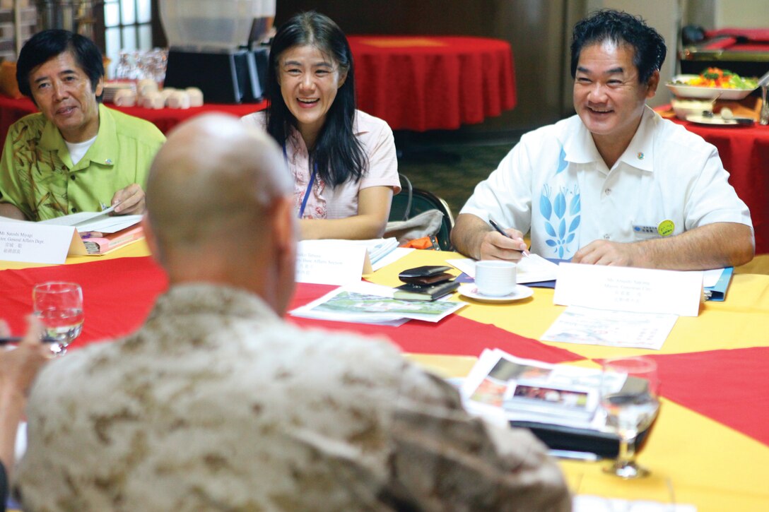 Atsushi Sakima, right, signs a mutual agreement with Col. James G. Flynn Aug. 23 on Marine Corps Air Station Futenma. The agreement allows emergency vehicles from the city to pass through MCAS Futenma, facilitating faster emergency response. Sakima is the mayor of Ginowan City. Flynn is the commanding officer of MCAS Futenma.
