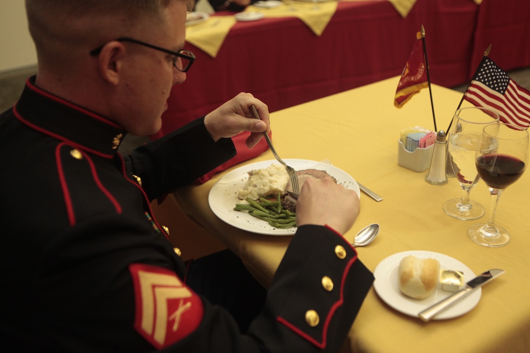 Cpl. Nathan W. Poulter, an EA-6B Prowler airframe mechanic and student with Cherry Point Corporals Leadership Course 274-12, enjoys his meal during a mess night at Millers Landing here Aug. 23. Boulter was vice president of mess. The second week of the course served to build confidence in leadership in the areas of operations, introduction to war fighting, communication, after action reports, weapons handling, and a continuation to their preview of sword and guidon manual. The students finished off their week of hard work by participating the 