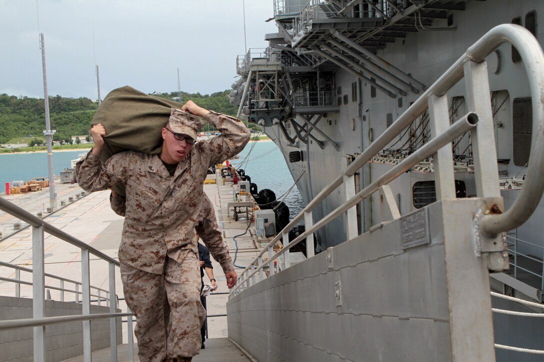 WHITE BEACH, Okinawa, Japan -Corporal Cole B. Stone, an air frames mechanic with Marine Medium Helicopter Squadron 262 (Reinforced) with the 31st Marine Expeditionary Unitand native of Fargo, N. D., boards the USS Bonhomme Richard of Amphibious Squadron 11 to begin a scheduled patrol of the Asia-Pacific region. The upcoming patrol is designed to continue the unit's multilateral training with allied nations in the region, while maintaining a ready force at sea and contributing to theater security cooperation. The 31st MEU is the Marine Corps' force in readiness for the Asia-Pacific region.