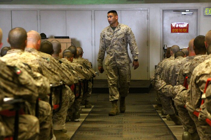 Staff Sgt. Valentin Monroy, the testing staff non-commissioned officer in charge, Academic Instructors Platoon, Support Battalion, walks up and down the aisles of the classroom during his class on Marine Corps history aboard Marine Corps Recruit Depot San Diego Aug. 16. The class was given to recruits of Company A, 1st Recruit Training Battalion, to further their knowledge of Marine Corps History and to provide insight on previous operations Marines have taken part in.