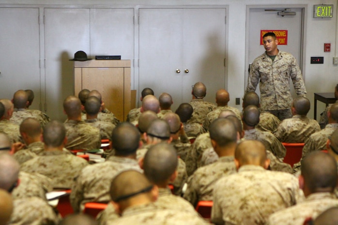 Staff Sgt. Valentin Monroy, the testing staff non-commissioned officer in charge, Academic Instructors Platoon, Support Battalion, walks up and down the aisles of the classroom during his class on Marine Corps History aboard Marine Corps Recruit Depot San Diego Aug. 16. The class was given to recruits of Company A, 1st Recruit Training Battalion, to further their knowledge of Marine Corps History and to provide insight on previous operations Marines have taken part in.