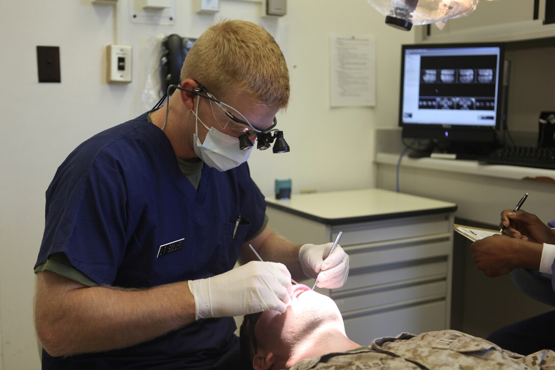 Navy Lt. Arthur N. Sollee, a dental officer with 2nd Dental Battalion, 2nd Marine Logistics Group, checks a patient’s teeth aboard Camp Lejeune, N.C., Aug. 22, 2012.  Dental officers with 2nd Dental Bn. are responsible for maintaining the dental readiness of nearly 60,000 servicemembers stationed aboard Marine Corps Base Camp Lejeune and Marine Corp Air Stations New River and Cherry Point. 