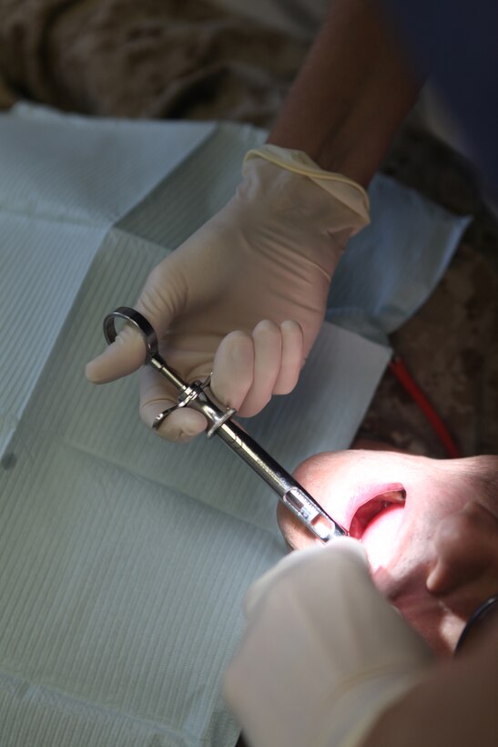 A dental officer with 2nd Dental Battalion, 2nd Marine Logistics Group applies anesthesia to a patient before working on his teeth aboard Camp Lejeune, N.C., Aug. 22, 2012.  Dental officers with 2nd Dental Bn. are responsible for maintaining the dental readiness of nearly 60,000 servicemembers stationed aboard Marine Corps Base Camp Lejeune and Marine Corp Air Stations New River and Cherry Point.