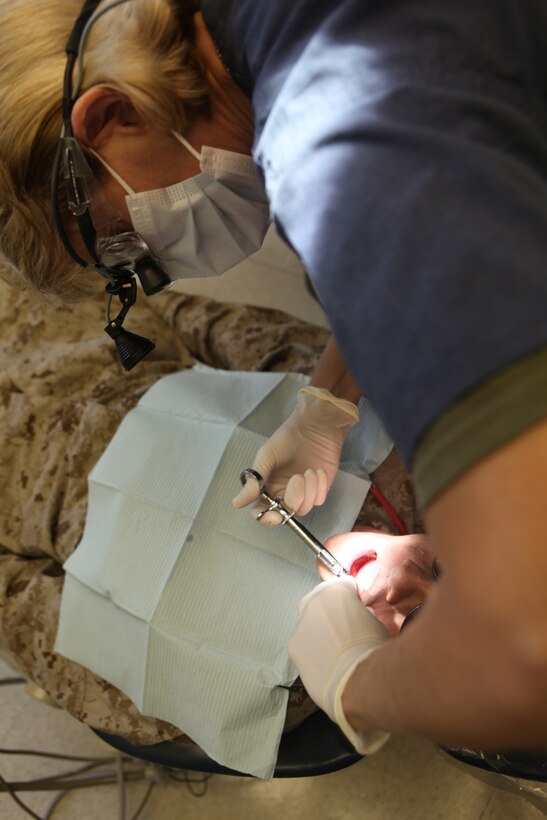 Cmdr. Cinthya E. Moorefield, a dental officer with 2nd Dental Battalion, 2nd Marine Logistics Group applies anesthesia to a patient before working on his teeth aboard Camp Lejeune, N.C., Aug. 22, 2012.  Dental officers with 2nd Dental Bn. are responsible for maintaining the dental readiness of nearly 60,000 servicemembers stationed aboard Marine Corps Base Camp Lejeune and Marine Corp Air Stations New River and Cherry Point.