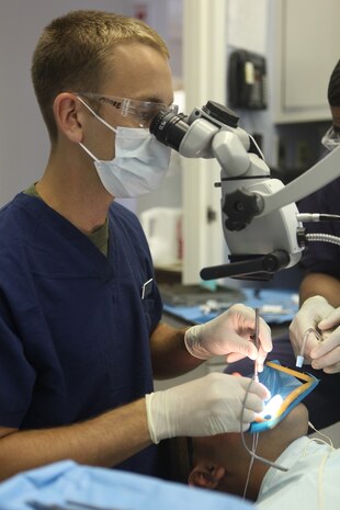 A dental officer with 2nd Dental Battalion, 2nd Marine Logistics Group performs oral surgery on a patient aboard Camp Lejeune, N.C., Aug. 22, 2012.  Dental officers with 2nd Dental Bn. are responsible for maintaining the dental readiness of nearly 60,000 servicemembers stationed aboard Marine Corps Base Camp Lejeune and Marine Corp Air Stations New River and Cherry Point. 