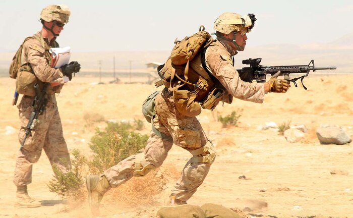 Marine Corps Air Ground Combat Center Twentynine Palms, Calif.-Lance Cpl. Thomas Overzet, rifleman, 1st Battalion, 4th Marine Regiment, conducts buddy rushes on Range 105 Aug. 14, 2012. Approximately 150 Marines are visiting the Combat Center from Marine Corps Base Camp Pendleton, Calif. as part of their Tactical Small Unit Leaders Course.