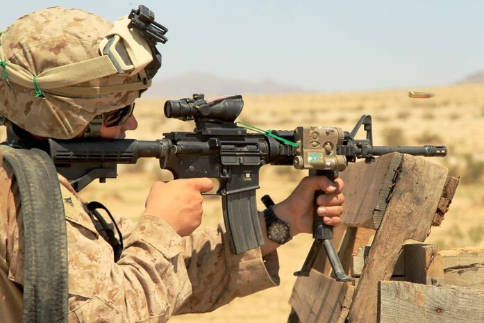 Marine Corps Air Ground Combat Center Twentynine Palms, Calif.-Lance Cpl. Thomas Overzet, rifleman, Company A, 1st Battalion, 4th Marine Regiment, fires a round during a buddy rushing exercise at Range 105, as part of the unit's Tactical Small Unit Leaders Course, Aug. 14, 2012.