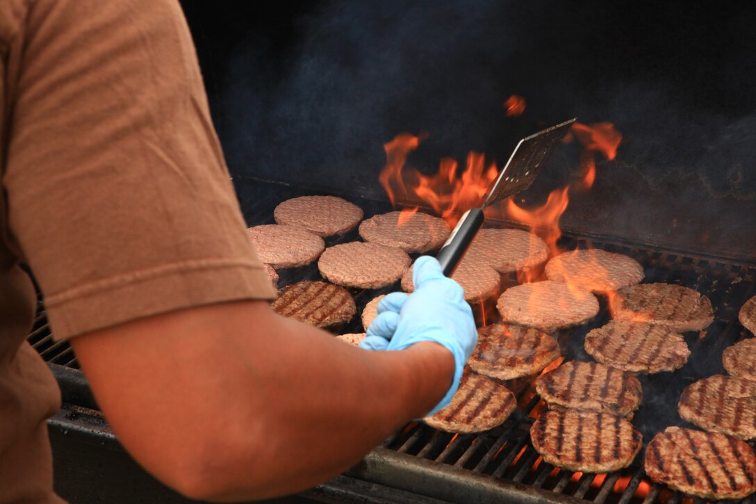 A Marine with Combat Logistics Regiment 27, 2nd Marine Logistics Group grills burgers for the regiment’s troops during a beach bash aboard Camp Lejeune, N.C., Aug. 30, 2012. The troops gathered to bond and celebrate their hard work with freshly grilled food and friendly competition during the six-hour event. 
