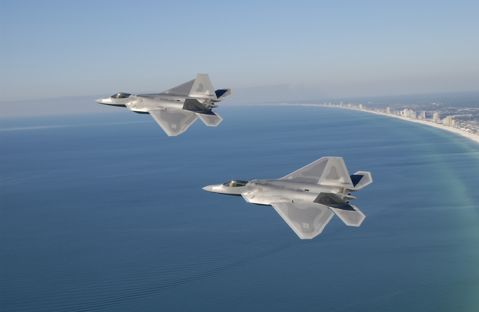 A pair of F-22 Raptors fly near the coastline of Panama City Beach, Fla. (Courtesy photo)