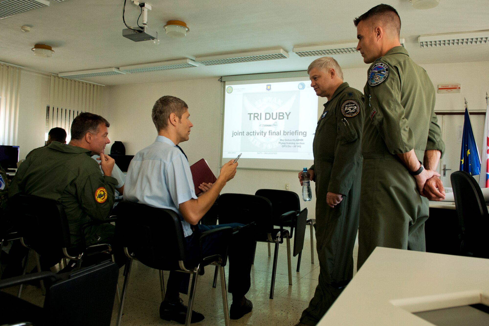 U.S. Air Force Lt. Col. Rick Holt, 93rd Bomb Squadron electronic warfare officer, and Capt. Kerry Baker, 93 BS radar navigator, discuss mission details with Slovak Air Force Capt. Tomas Fasko, Military Aerial Control Center deputy commander, during a briefing on Aug. 30, 2012, Sliac Military Air Base, Sliac, Slovakia. A 93 BS B-52H Stratofortress is in Sliac to support the Slovak International Air Fest and on its departure will participate in a training mission involving SAF surface-to-air missile defense systems and MiG-29 Fulcrum fighter aircraft. (U.S. Air Force photo by Master Sgt. Greg Steele/Released)