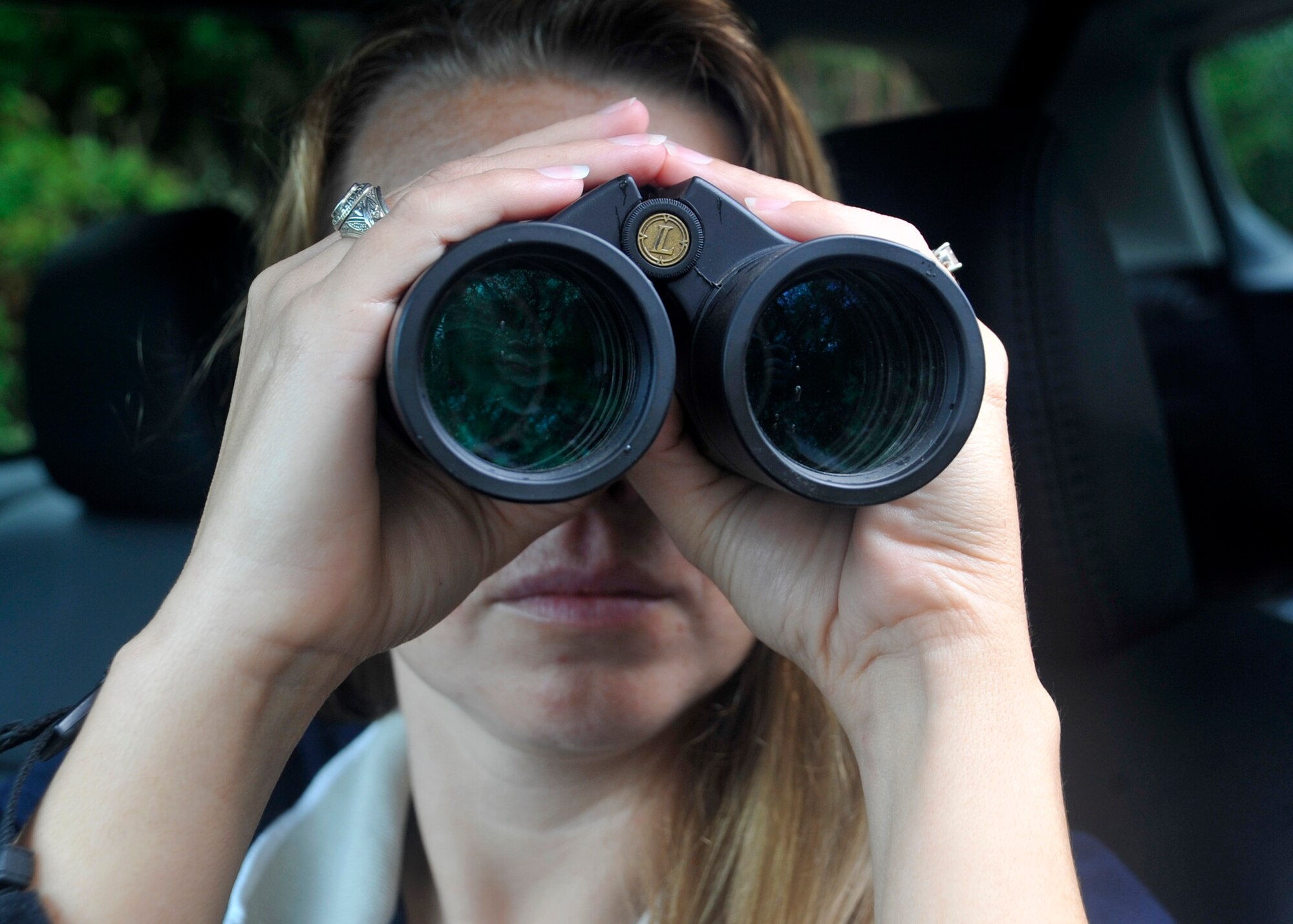 Melody Henderson, Bird/Wildlife Aircraft Strike Hazard ecologist, looks through a pair of binoculars at an Osprey nest Aug. 28, 2012, at Pioneer near Dover Air Force Base, Del. Henderson tries to keep birds and other wildlife on an off base from interfering with aircraft, Osprey have been known to cause damage to aircraft. (U.S. Air Force photo by Tech. Sgt. Chuck Walker)