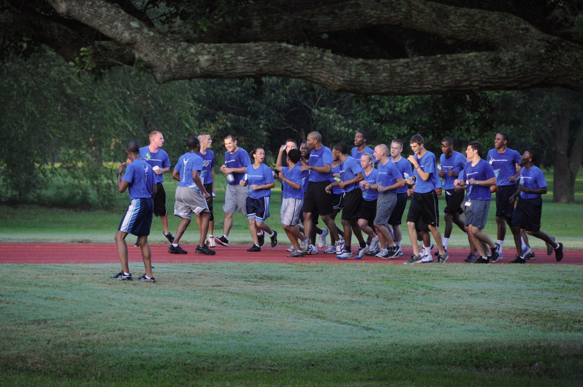 Trainees with the 315th Airlift Wing Development and Training Flight join together and encourage a wingman during the last lap of a 1.5 mile fitness run Aug. 4, 2012 at Joint Base Charleston, S.C. The trainees are part of the 315 AW DTF program and participation is mandatory for all newly enlisted Airmen and serves as part of their enlistment into the inactive Reserve while awaiting positions to open in Basic Military Training. (U.S. Air Force Photo/Staff Sgt. Shane Ellis)