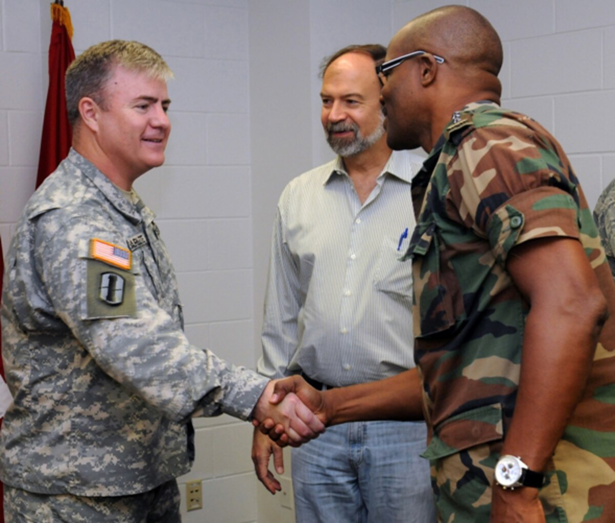 RAPID CITY, S.D. - Brig. Gen. Jeff Marlette (left), assistant adjutant general of the South Dakota Army National Guard, welcomes Col. Hedwig Gilaard, Suriname Chief of Armed Forces, to Camp Rapid in Rapid City, S.D., as U.S. Ambassador to Suriname Mr. John Nay looks on Wednesday, June 15, 2011. The dignitaries were shown various military training associated with the annual Golden Coyote training exercise, which brought 2,100 National Guard Soldiers and Airmen from across the U.S. to the Black Hills for the two-week training event. (SDNG photo by OC Chad Carlson) (RELEASED)