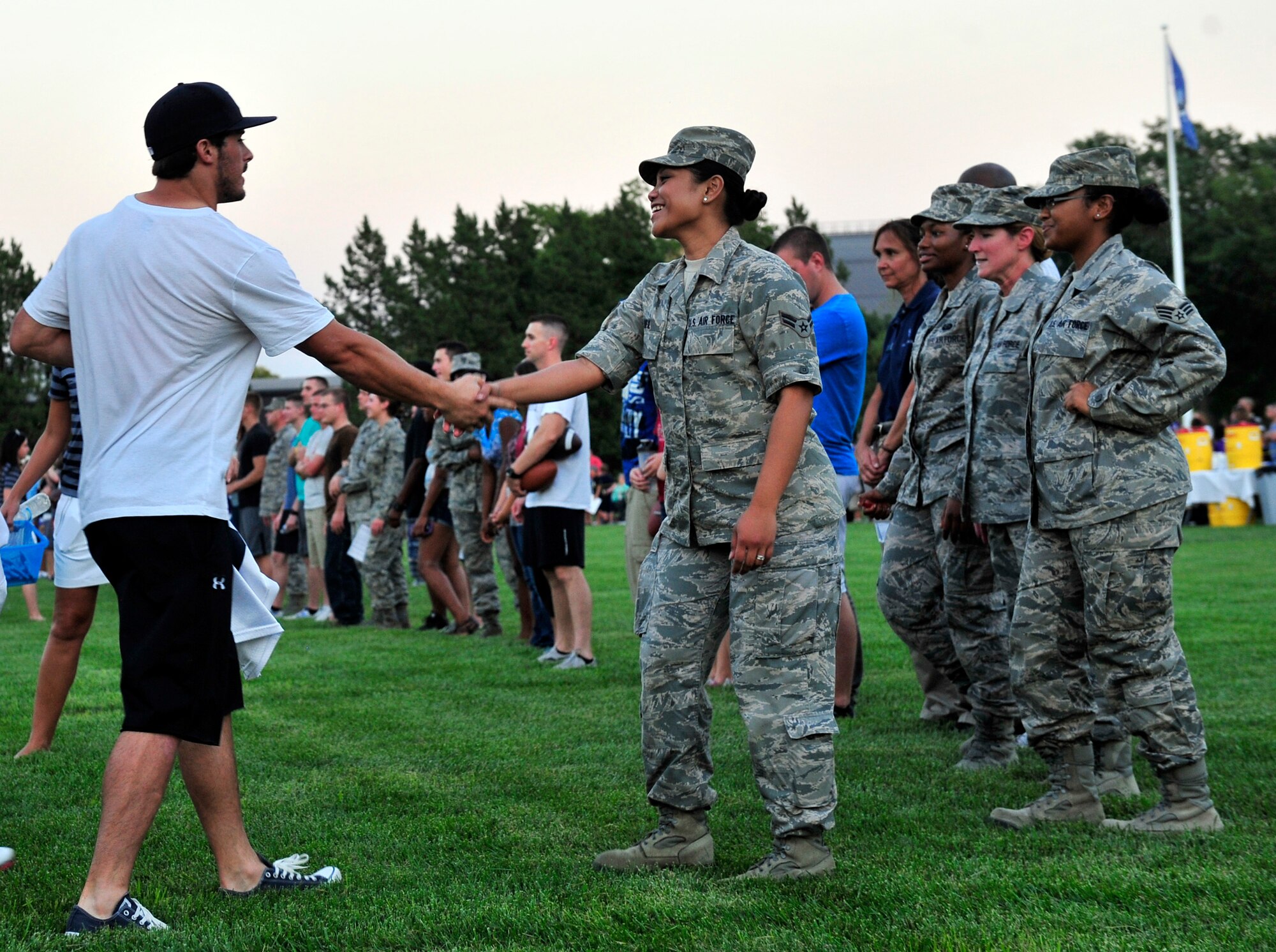 Members of the St. Louis Rams special teams unit hand off practice jersies to Team Scott members after a walk through practice Aug. 29 at Scott Air Force Base, Ill. Military members received a rare opportunity to play in a practice walk through against professional football players. (U.S. Air Force photo/Staff Sgt. Stephenie Wade)
