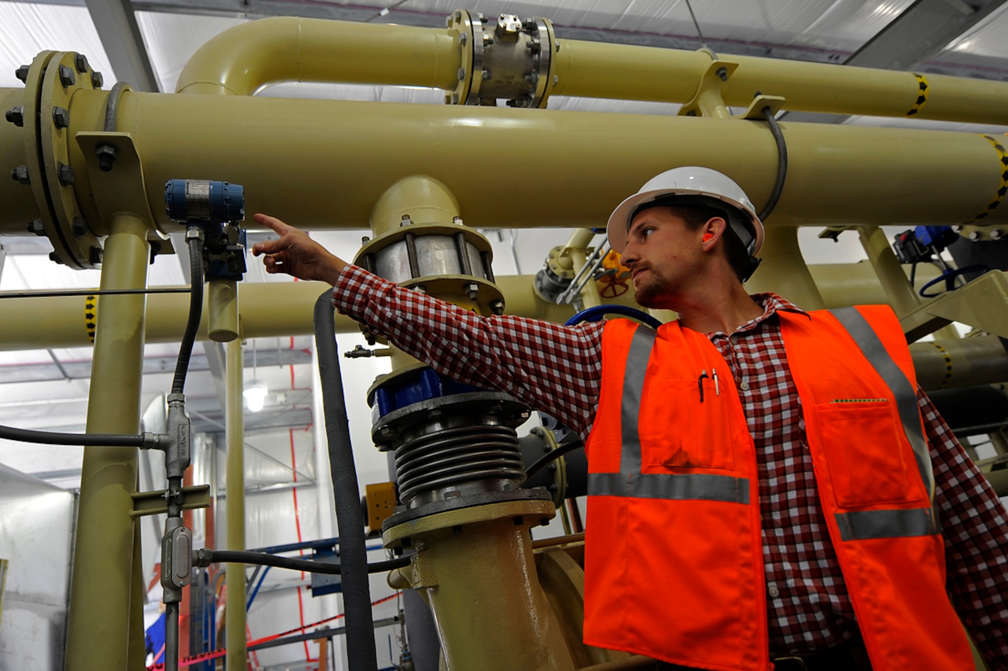 Greg Mitchell checks the pressure on the landfill gas processing module, being constructed at the Anchorage Landfill, Aug. 21. Once operational, the module will clean and dry the landfill gas before it is sent to the plant. Mitchell is the Joint Base Elmendorf-Richardson Landfill Gas Plant operator. (U.S. Air Force photo/Tech. Sgt. Brian Ferguson)