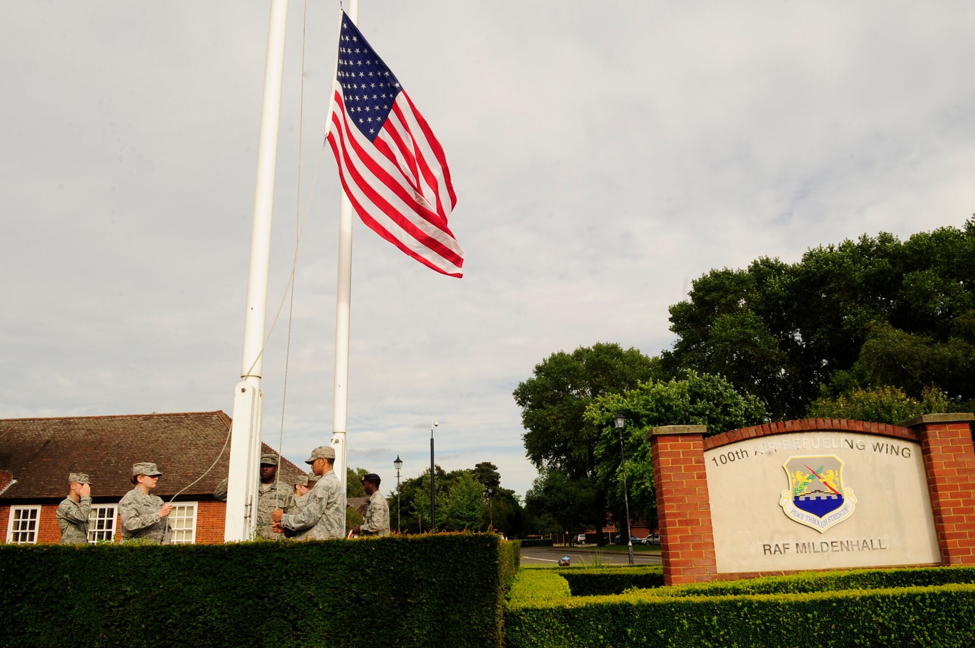 RAF MILDENHALL, England – Airmen from the 100th Mission Support Group lowers the American flag during a retreat ceremony Aug. 31, 2012, at RAF Mildenhall. Retreat signals the end of the duty day while also paying respect to the American flag. (U.S. Air Force photo/Senior Airman Ethan Morgan)