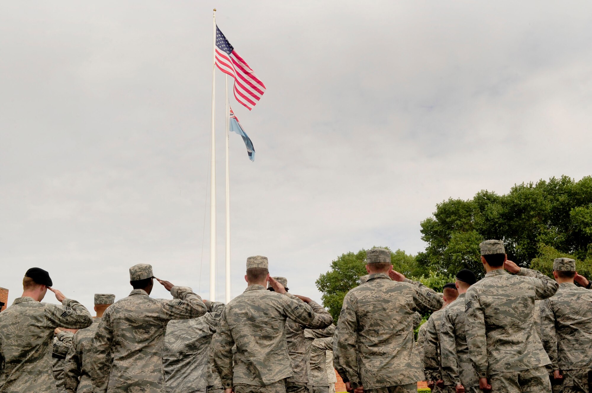 RAF MILDENHALL, England -- Airmen from the 100th Mission Support Group salute the American and Royal Air Force Ensign during a retreat ceremony Aug. 31, 2012, at RAF Mildenhall. The monthly ceremony was hosted by the 100th MSG and signals the end of the duty day. (U.S. Air Force photo/Senior Airman Ethan Morgan)
