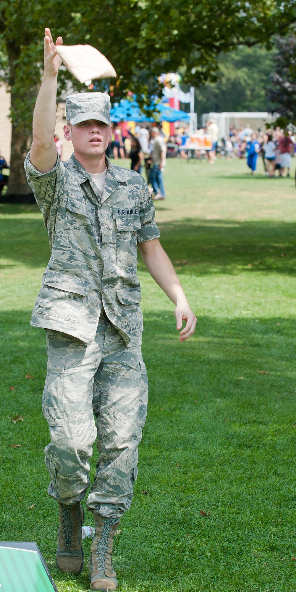 Airman 1st Class Curtis Hanna, 87th Medical Group optometry office optometry technician, throws a bean bag during a cornhole game Aug. 24 at the Joint Base McGuire-Dix-Lakehurst Annual Summer Picnic on Doughboy Field. Picnic participants had a multitude of games and activity options to choose from including horseshoes to relay races. (U.S. Air Force photo by Wayne Russell /Released)