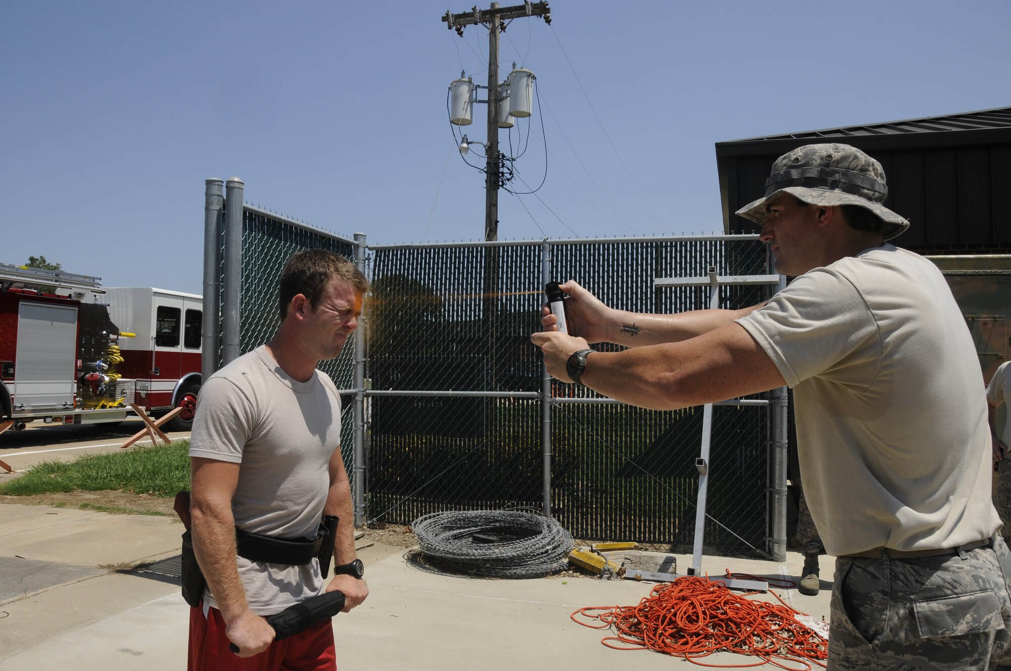 Airmen with the 188th Security Forces Squadron participated in Oleoresin Capsicum "pepper" spray training Aug. 4, 2012. Members of the SFS were pepper sprayed in the face and then had to subdue a perpetrator, which included using a baton to fend off two attackers, drawing their service weapon and conducting handcuffing procedures. (National Guard photo by Airman 1st Class Hannah Landeros/188th Fighter Wing Public Affairs)

