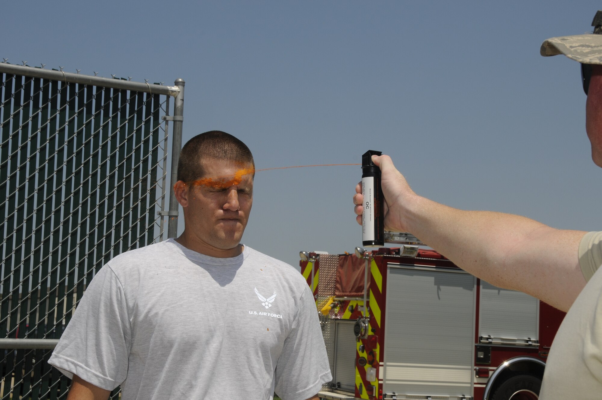 Airmen with the 188th Security Forces Squadron participated in Oleoresin Capsicum "pepper" spray training Aug. 4, 2012. Members of the SFS were pepper sprayed in the face and then had to subdue a perpetrator, which included using a baton to fend off two attackers, drawing their service weapon and conducting handcuffing procedures. (National Guard photo by Airman 1st Class Hannah Landeros/188th Fighter Wing Public Affairs)

