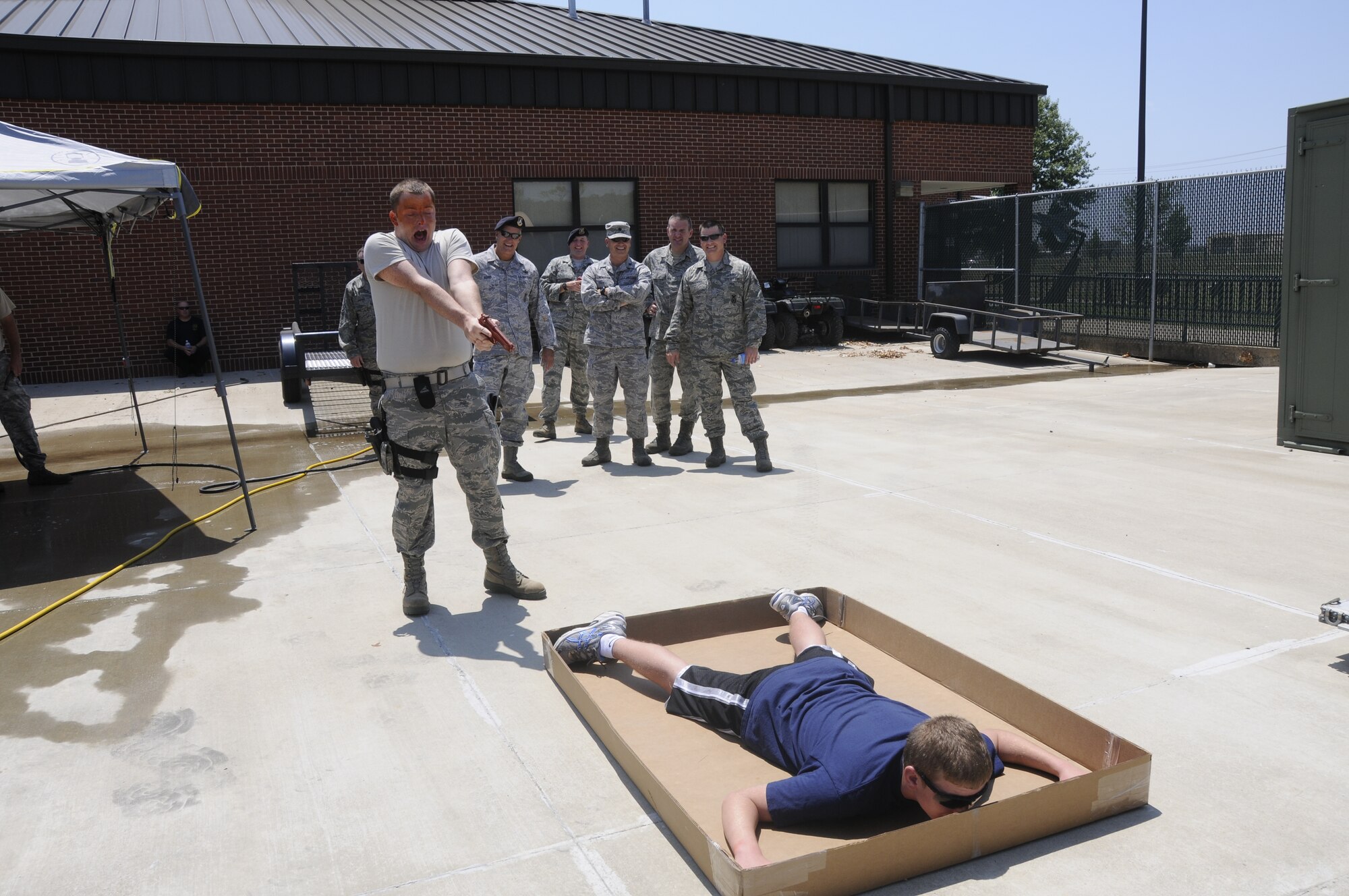 Airmen with the 188th Security Forces Squadron participated in Oleoresin Capsicum "pepper" spray training Aug. 4, 2012. Members of the SFS were pepper sprayed in the face and then had to subdue a perpetrator, which included using a baton to fend off two attackers, drawing their service weapon and conducting handcuffing procedures. (National Guard photo by Airman 1st Class Hannah Landeros/188th Fighter Wing Public Affairs)

