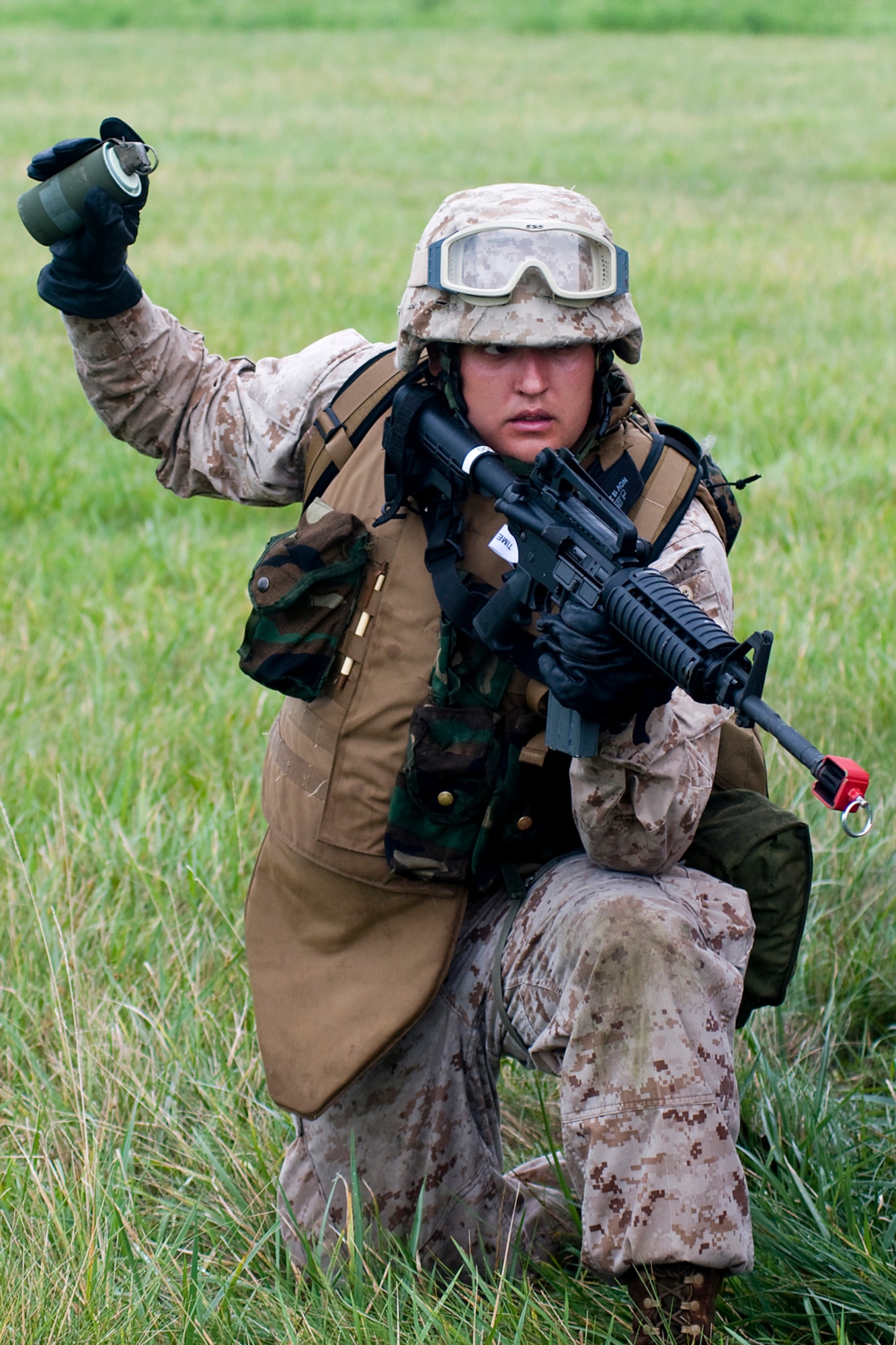 GRISSOM AIR RESERVE BASE, Ind. -- U.S. Marine Corps Reserve Cpl. Daniel Lewis prepares to throw a smoke grenade to indicate a landing zone for an approaching UH-60 Black Hawk during a joint forces exercise here Aug. 5.  Lewis is assigned to Detachment 1, Communications Company, Headquarters and Service Battalion, 4th Marine Logistics Group here, and the Black Hawk was from the Indiana National Guard. (U.S. Air Force photo/Senior Airman Jami Lancette)