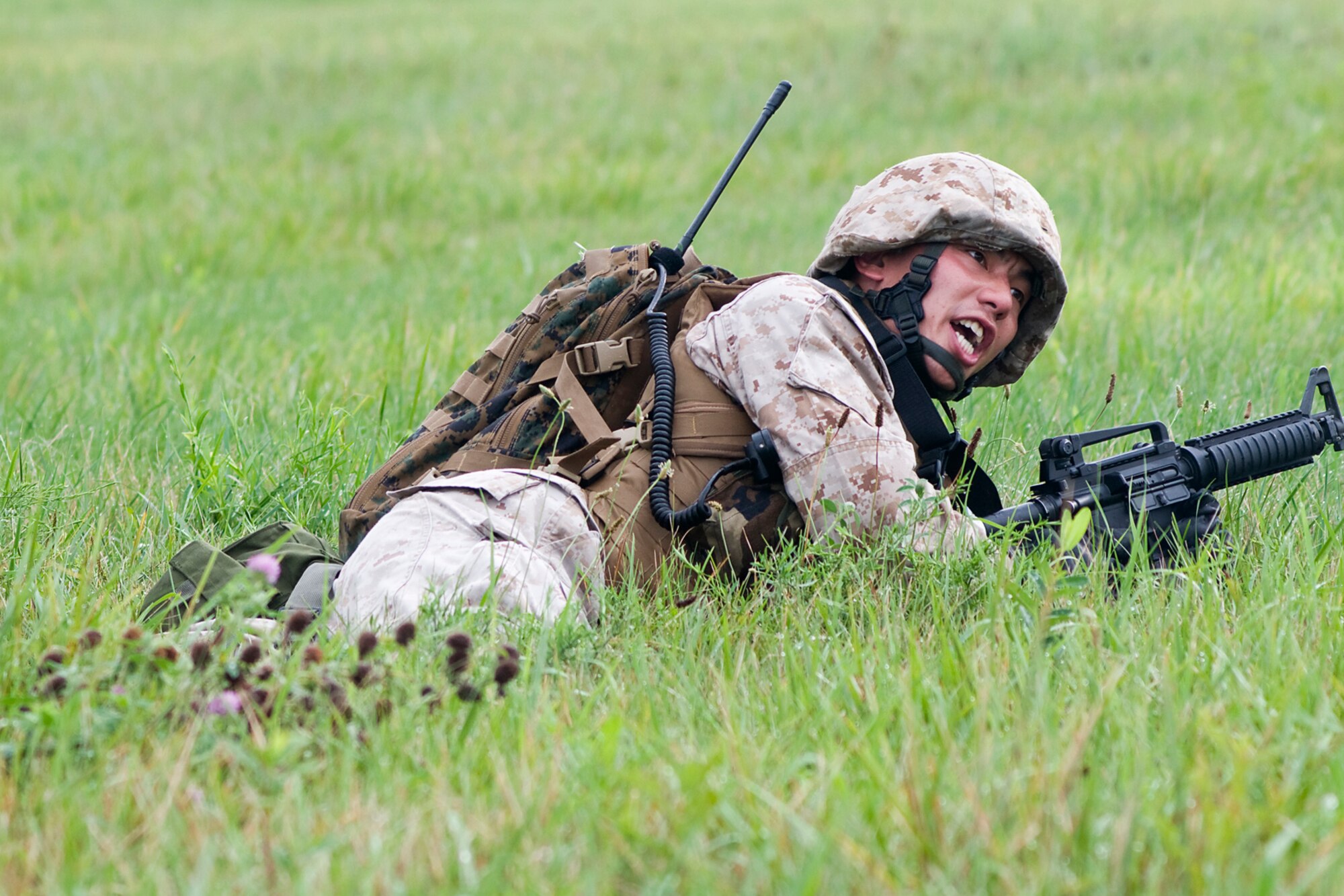 GRISSOM AIR RESERVE BASE, Ind. -- U.S. Marine Corps Reserve Cpl. Joseph Chen yells at his squad to advance on an enemy position during a joint exercise held here Aug. 5. Grissom's Air Force Reserve, Army Reserve and Marine Reserve units all participated in the exercise aimed at providing invaluable training for life-or-death scenarios. Chen is assigned to Detachment 1, Communications Company, Headquarters and Service Battalion, 4th Marine Logistics Group here. (U.S. Air Force photo/Senior Airman Jami Lancette)
