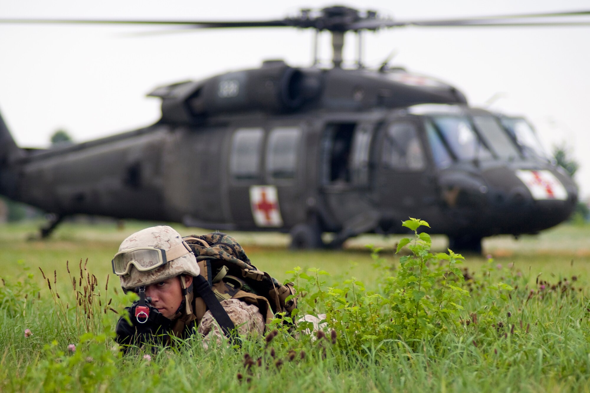 GRISSOM AIR RESERVE BASE, Ind. -- U.S. Marine Corps Reserve Lance Cpl. Brian Napier guards a UH-60 Black Hawk from the Indiana Army National Guard's 2-238th General Support Aviation Battalion Medical Evacuation Unit during a joint forces exercise here Aug. 5. Napier is assigned to Detachment 1, Communications Company, Headquarters and Service Battalion, 4th Marine Logistics Group here. (U.S. Air Force photo/Tech. Sgt. Mark R. W. Orders-Woempner)
