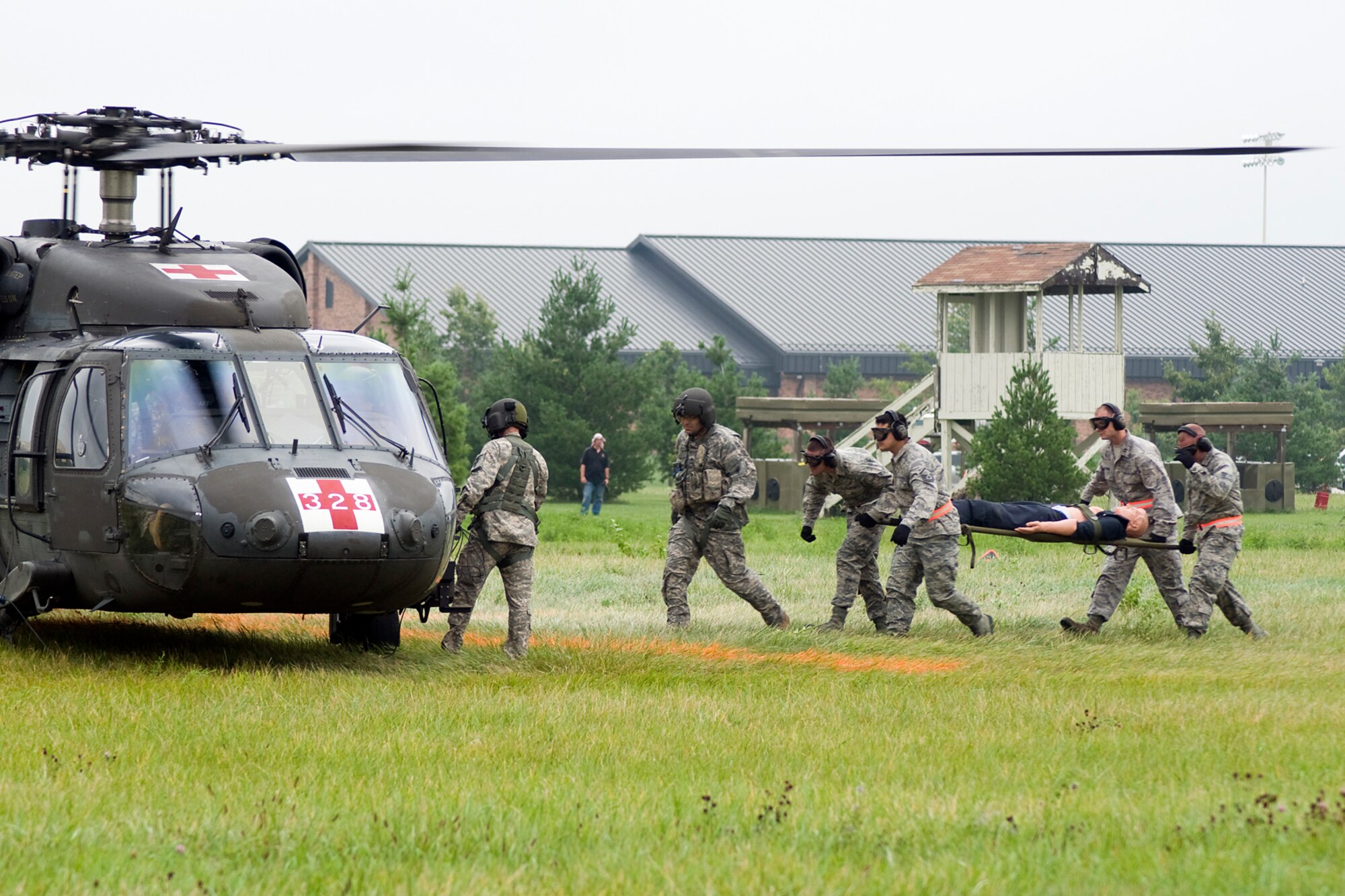 GRISSOM AIR RESERVE BASE, Ind. -- U.S. Air Force Reserve personnel transport a simulated wounded Soldier to a waiting UH-60 Black Hawk from the Indiana Army National Guard's 2-238th General Support Aviation Battalion Medical Evacuation Unit for transport to a medical facility during a joint forces exercise here Aug. 5. The Army Guard participated in the exercise that also included Grissom's Air Force Reserve, Army Reserve and Marine Corps Reserve units. (U.S. Air Force photo/Tech. Sgt. Mark R. W. Orders-Woempner)
