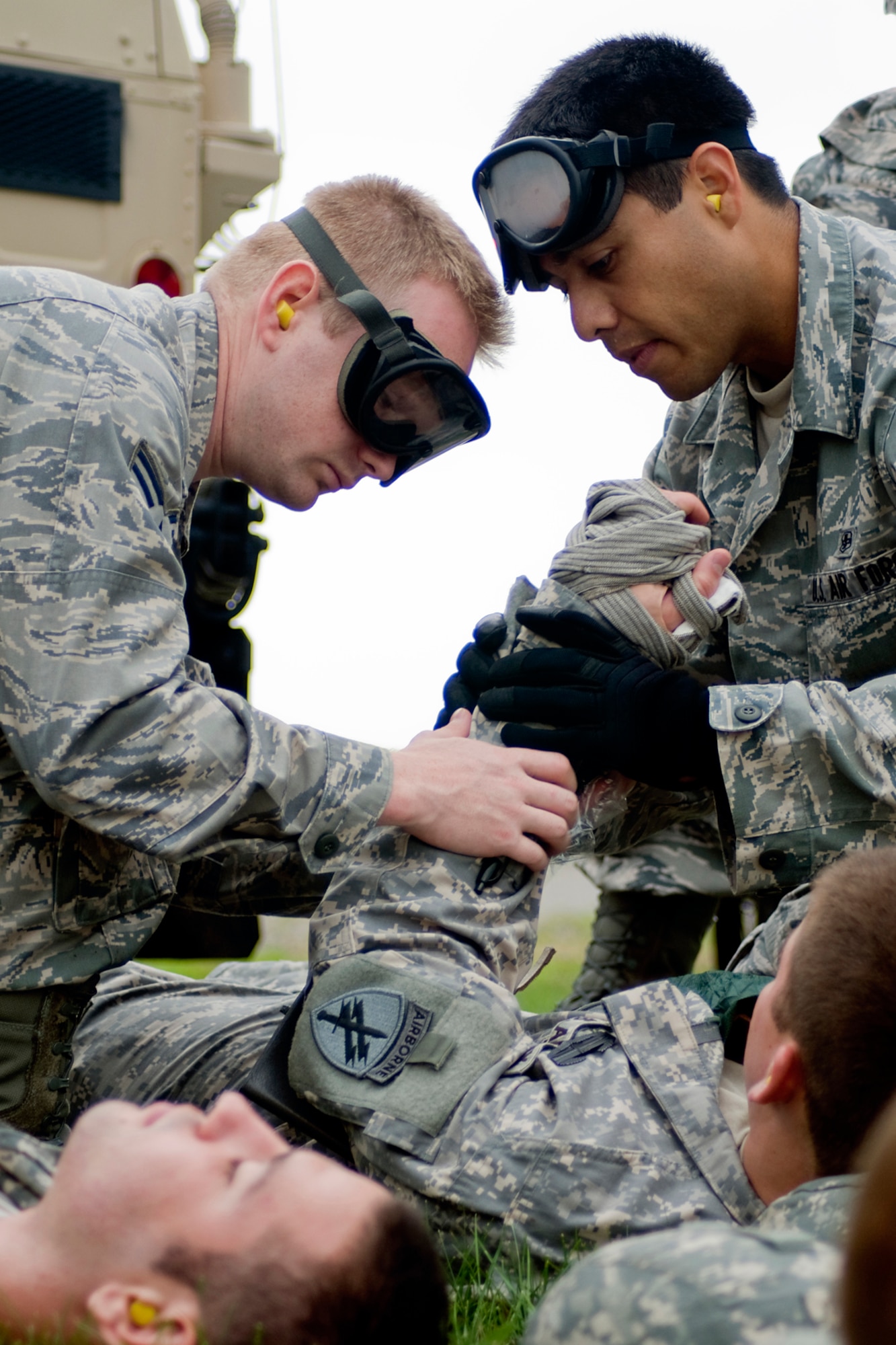 GRISSOM AIR RESERVE BASE, Ind. -- U.S. Air Force Reserve Senior Airmen Cameron Harney and Omar Tellez, both 434th Aerospace Medicine Squadron aerospace medical apprentices, tend to a U.S. Army Reserve Soldier's simulated wounds during a joint forces exercise held here Aug. 5. The exercise allowed 434th Aerospace Medicine Squadron aeromedical technicians to practice life-saving skills under a high-stress scenario. (U.S. Air Force photo/Tech. Sgt. Mark R. W. Orders-Woempner)
