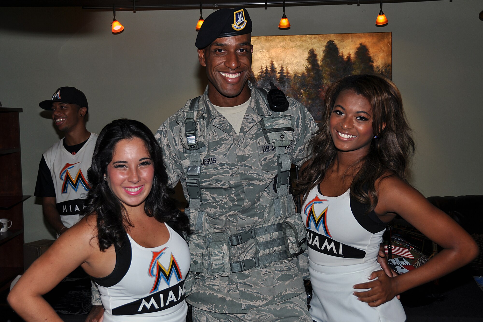 Senior Airman Jose De Jesus, Security Forces Patrolman 482d Security Forces Squadron poses, with the Miami Marlin Energy Team for a photo during the Miami Marlins visit to the base Aug, 20. Their third time visiting HARB, the Miami Marlins Energy Team handed out free game tickets and fan paraphernalia such as water bottles, bags and player bobble-head dolls, while Billy Marlin entertained, posed for pictures, and shook hands. 