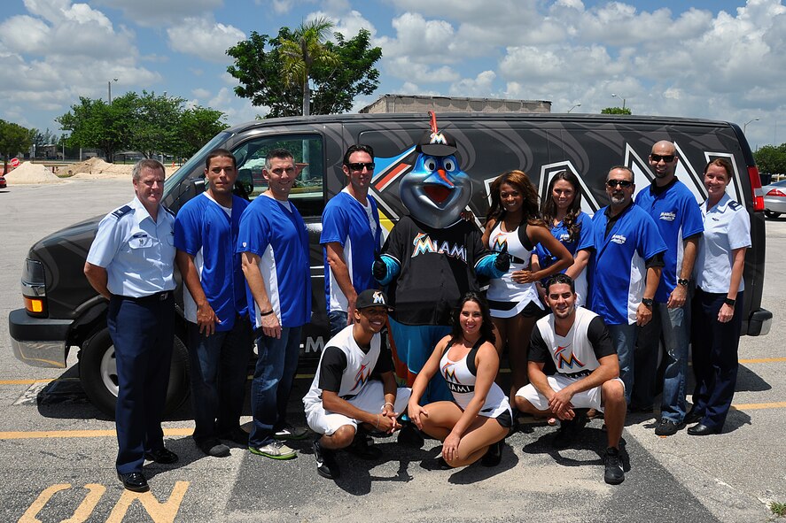 Col. David Davis, 482d Fighter Wing Vice Commander (Left) and Capt. Shannon Cary 482d Fighter Wing executive officer (right), pose with the Miami Marlins Energy Team and Billy the Marlin during the Miami Marlins visit to the base Aug, 20. Base personnel from the 482nd Fighter Wing, U.S. Coast Guard and Maritime Safety Team 91114, Special Operations Command South, and U. S. Customs and Border Protection Miami Air and Marine Branch participated in taking advantage of the fun filled event. 