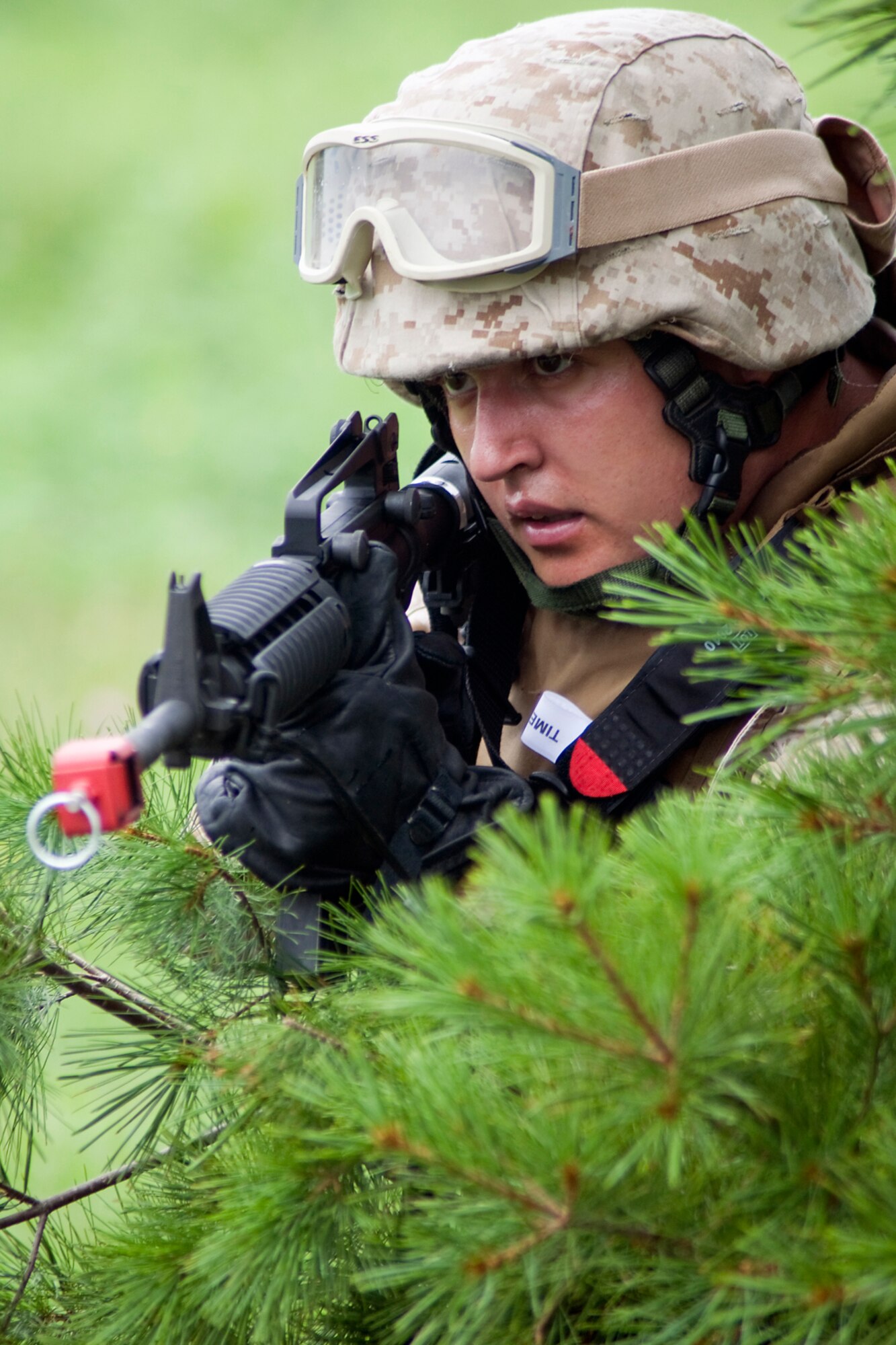 GRISSOM AIR RESERVE BASE, Ind. -- U.S. Marine Corps Reserve Cpl. Daniel Lewis peeks through the trees as he guards a group of wounded U.S. Army Reserve Soldiers being tended to by Air Force Reserve medics during a joint forces exercise here Aug. 5. Lewis is assigned to Detachment 1, Communications Company, Headquarters and Service Battalion, 4th Marine Logistics Group here. (U.S. Air Force photo/Tech. Sgt. Mark R. W. Orders-Woempner)
