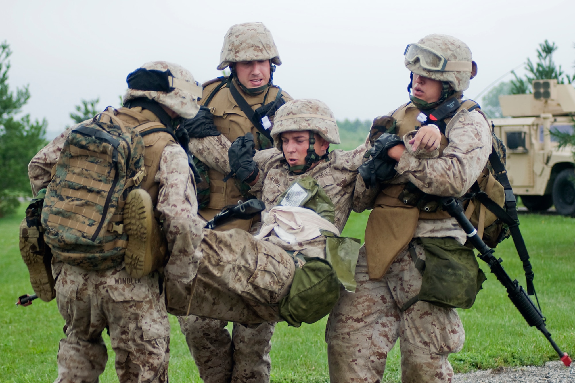 GRISSOM AIR RESERVE BASE, Ind. -- U.S. Marine Corps reservists from Detachment 1, Communications Company, Headquarters and Service Battalion, 4th Marine Logistics Group carry a fellow Marine who has a simulated stomach wound during a joint forces exercise here Aug. 5. Grissom's Air Force Reserve, Army Reserve and Marine Corps Reserve units all participated in the exercise aimed at providing invaluable training for life-or-death scenarios. (U.S. Air Force photo/Tech. Sgt. Mark R. W. Orders-Woempner)
