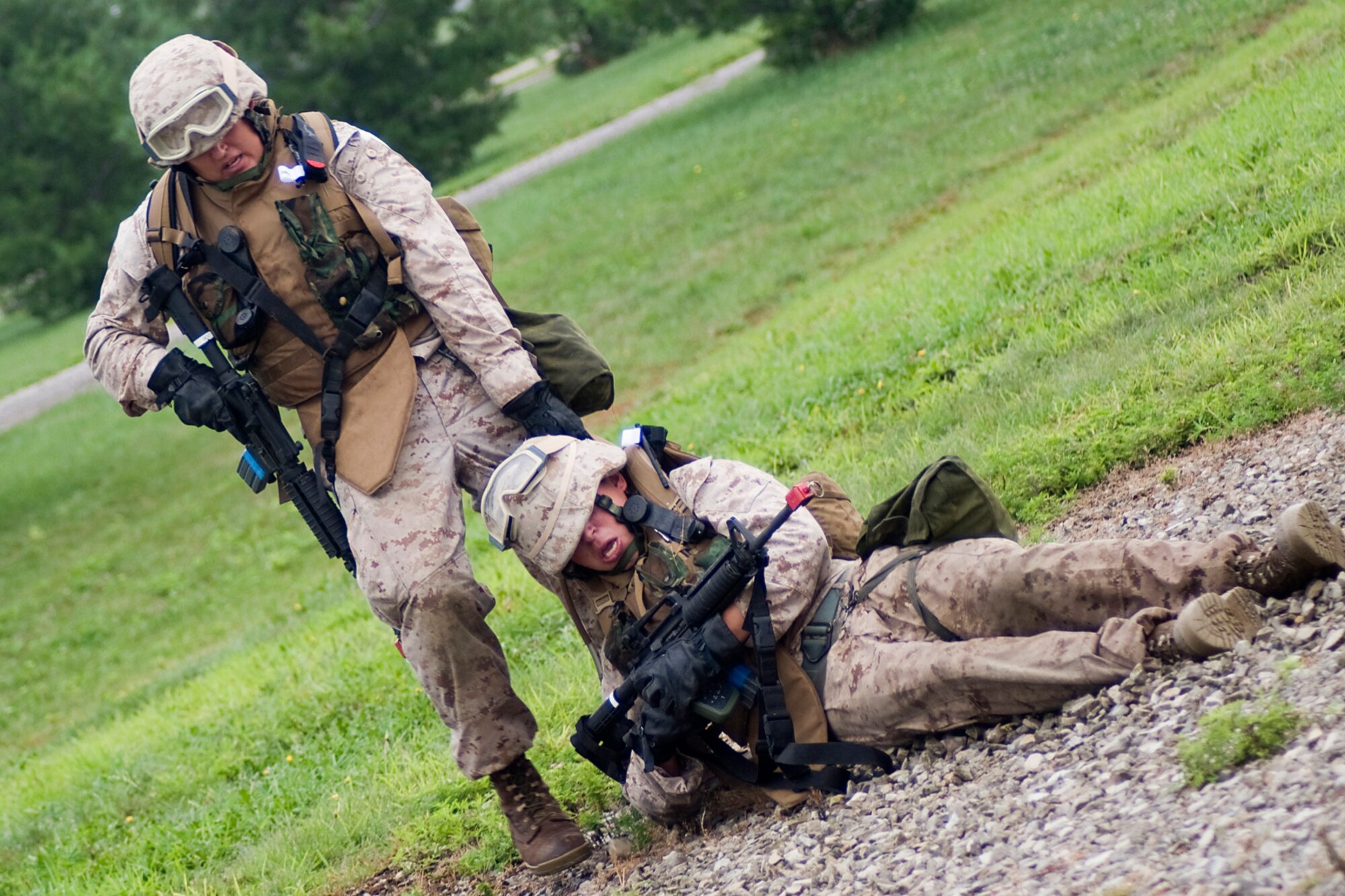 GRISSOM AIR RESERVE BASE, Ind. -- U.S. Marine Corps Reserve Cpl. Daniel Lewis drags a fellow Marine to safety after he received simulated wounds during a joint forces exercise here Aug. 5. Lewis is assigned to Detachment 1, Communications Company, Headquarters and Service Battalion, 4th Marine Logistics Group here. (U.S. Air Force photo/Tech. Sgt. Mark R. W. Orders-Woempner)
