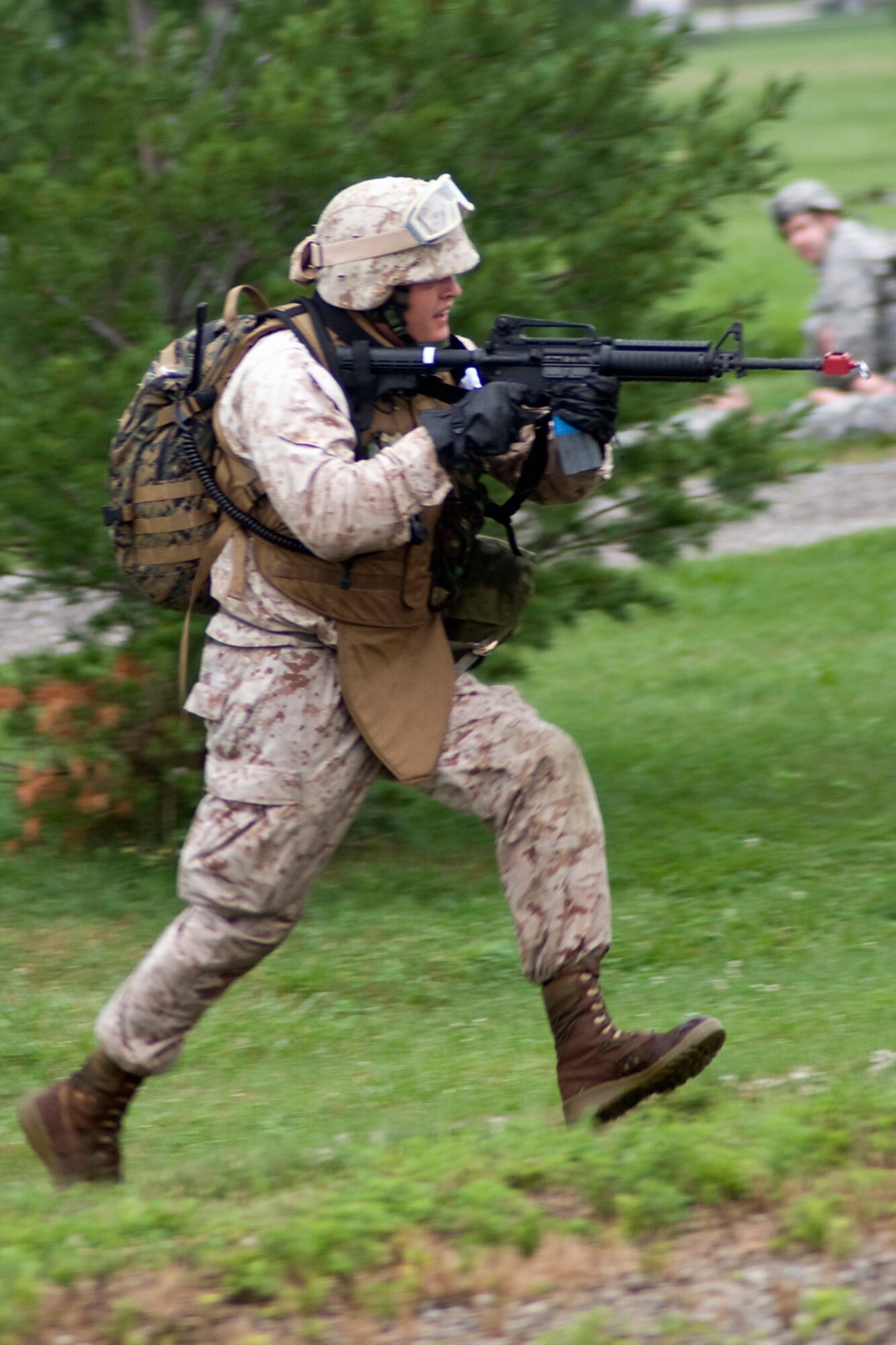 GRISSOM AIR RESERVE BASE, Ind. -- U.S. Marine Corps Reserve Cpl. Daniel Lewis races toward an enemy position during a joint forces exercise here Aug. 5.  Lewis is assigned to Detachment 1, Communications Company, Headquarters and Service Battalion, 4th Marine Logistics Group here. (U.S. Air Force photo/Tech. Sgt. Mark R. W. Orders-Woempner)
