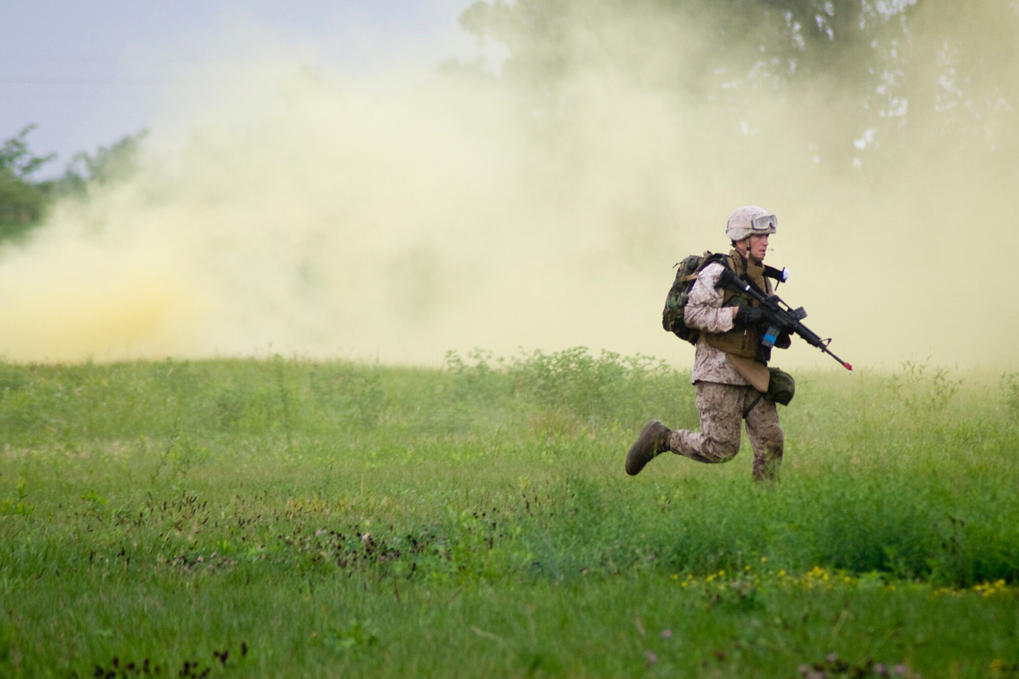 GRISSOM AIR RESERVE BASE, Ind. -- Running through a cloud of smoke, U.S. Marine Corps Reserve Lance Cpl. Brian Napier makes his way to an enemy position during a joint forces exercise here Aug. 5. Napier is assigned to Detachment 1, Communications Company, Headquarters and Service Battalion, 4th Marine Logistics Group here. (U.S. Air Force photo/Tech. Sgt. Mark R. W. Orders-Woempner)
