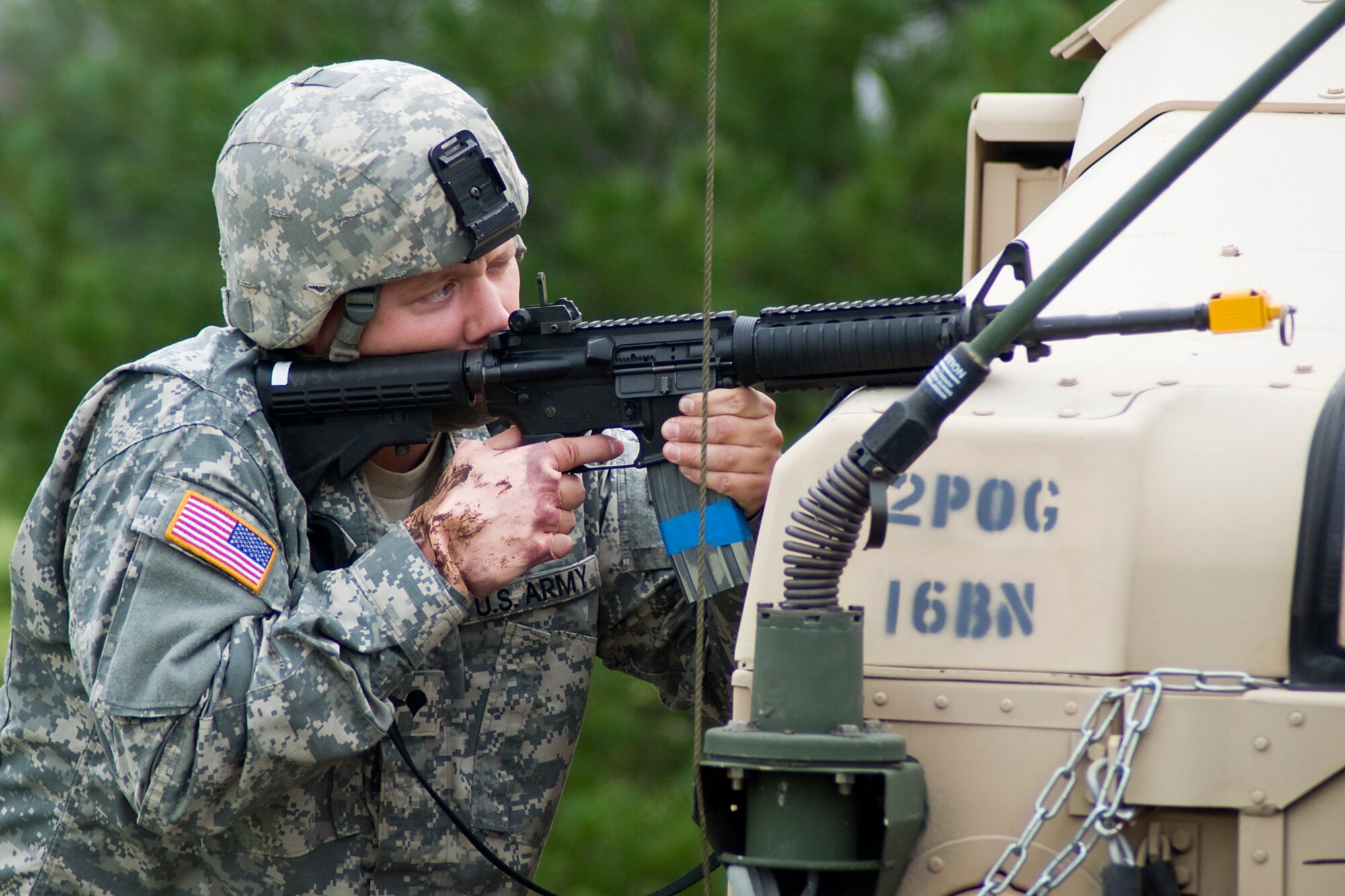 GRISSOM AIR RESERVE BASE, Ind. -- Setting his sights on an enemy sniper, U.S. Army Reserve Spc. Adam Ruddell, 316th Psychological Operations Company generator mechanic, responds after his patrol was hit by a simulated improvised explosive device during a joint forces exercise here Aug. 5. Grissom?s Air Force Reserve, Army Reserve and Marine Reserve units all participated in the exercise aimed at providing invaluable training for life-or-death scenarios. (U.S. Air Force photo/Tech. Sgt. Mark R. W. Orders-Woempner)
