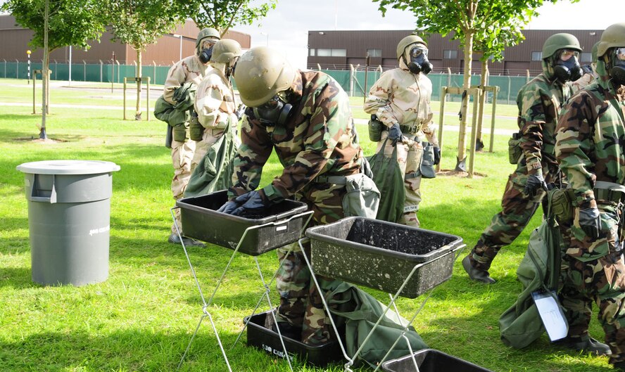 RAF MILDENHALL, England – Military members from the 100th Air Refueling Wing move through a decontamination line Aug. 28, 2012, at the simulated contamination control area outside Bldg. 680, as part of ability to survive and operate training. Members from the 100th ARW took part in the training in preparation for the upcoming operational readiness exercise. (U.S. Air Force photo/Karen Abeyasekere)