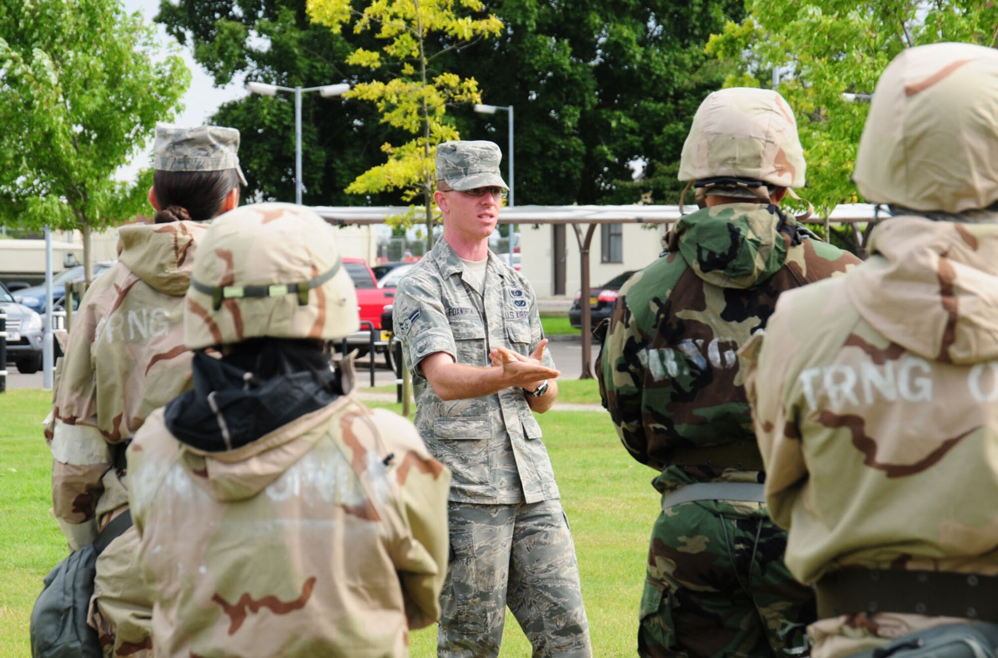 RAF MILDENHALL, England – Airman 1st Class Joshua Foxworth, center, 100th Civil Engineer Squadron Readiness and Emergency Management, talks to military members during the post-attack reconnaissance portion of the ability to survive and operate training Aug. 28, 2012, at Bldg. 680, RAF Mildenhall. Military members from the 100th Air Refueling Wing took part in the training in preparation for the upcoming operational readiness exercise. (U.S. Air Force photo/Karen Abeyasekere)