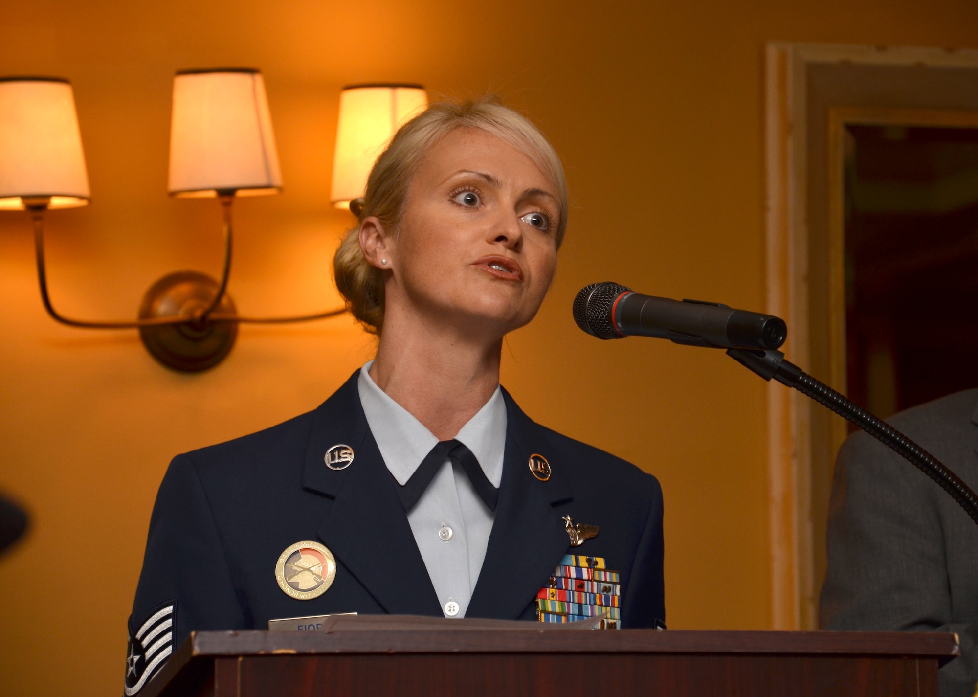 Tech. Sgt. Jennifer Fiore, HC-130P/N refueling aircraft radio operator, 920th Rescue Wing, Patrick Air Force Base, Fla., sings the national anthem to start off the 4th Annual Award ceremony Aug. 30. Recognized for their heroic efforts while successfully saving the lives of four men after their air boat flipped in the St. John's River earlier this year were nine Rescue Airmen. (U.S. Air Force photo/Senior Airman Natasha) 