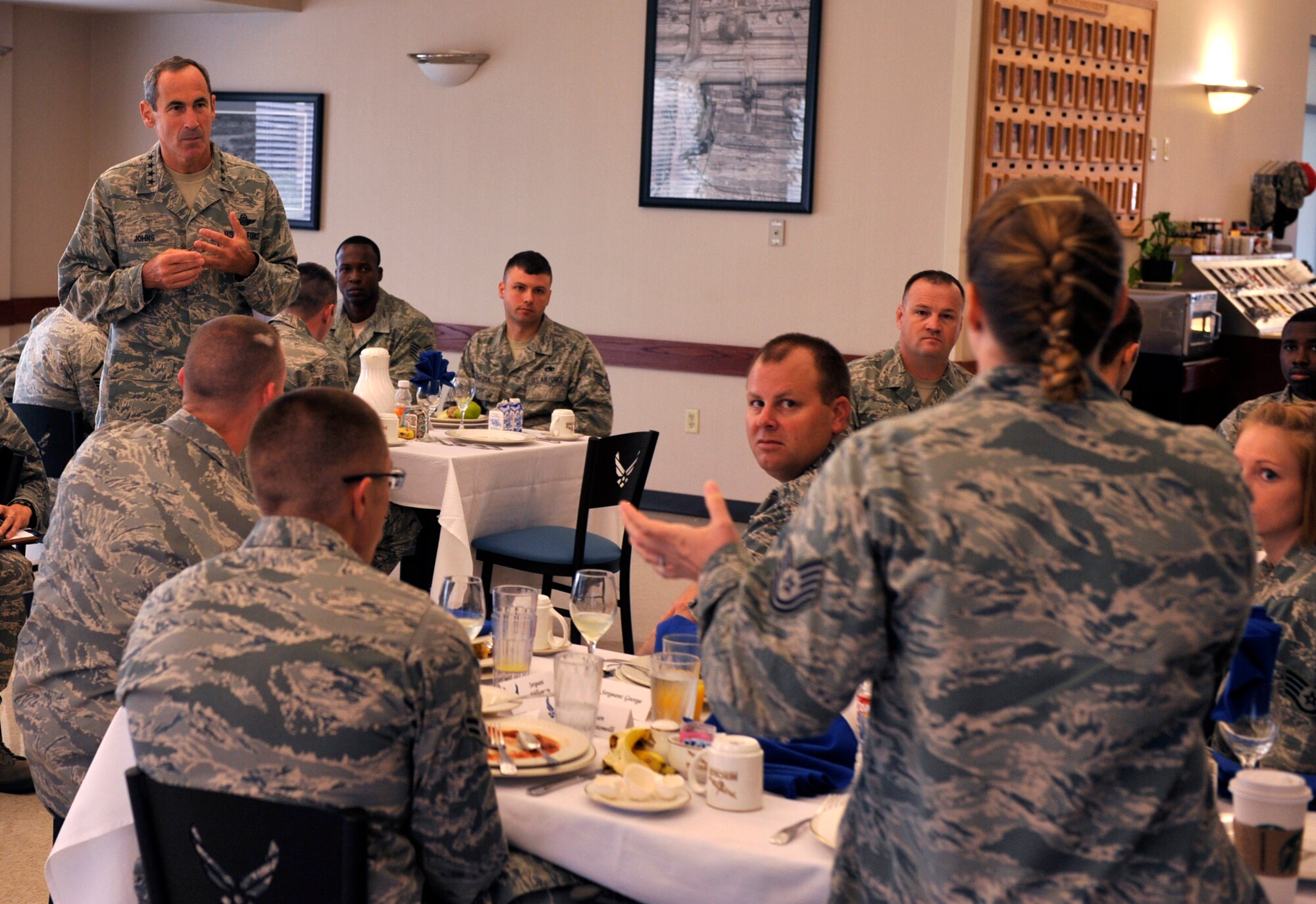 Tech. Sgt. Tina Grewell, 19th Operations Support Squadron weather flight non-commissioned officer in charge, asks a question to Gen. Raymond Johns, Air Mobility Command commander, Aug. 30, 2012, at Little Rock Air Force Base, Ark. Grewell was one of 15 Team Little Rock Airman involved in an open discussion with Johns. (U.S. Air Force photo/Airman 1st Class Rusty Frank)