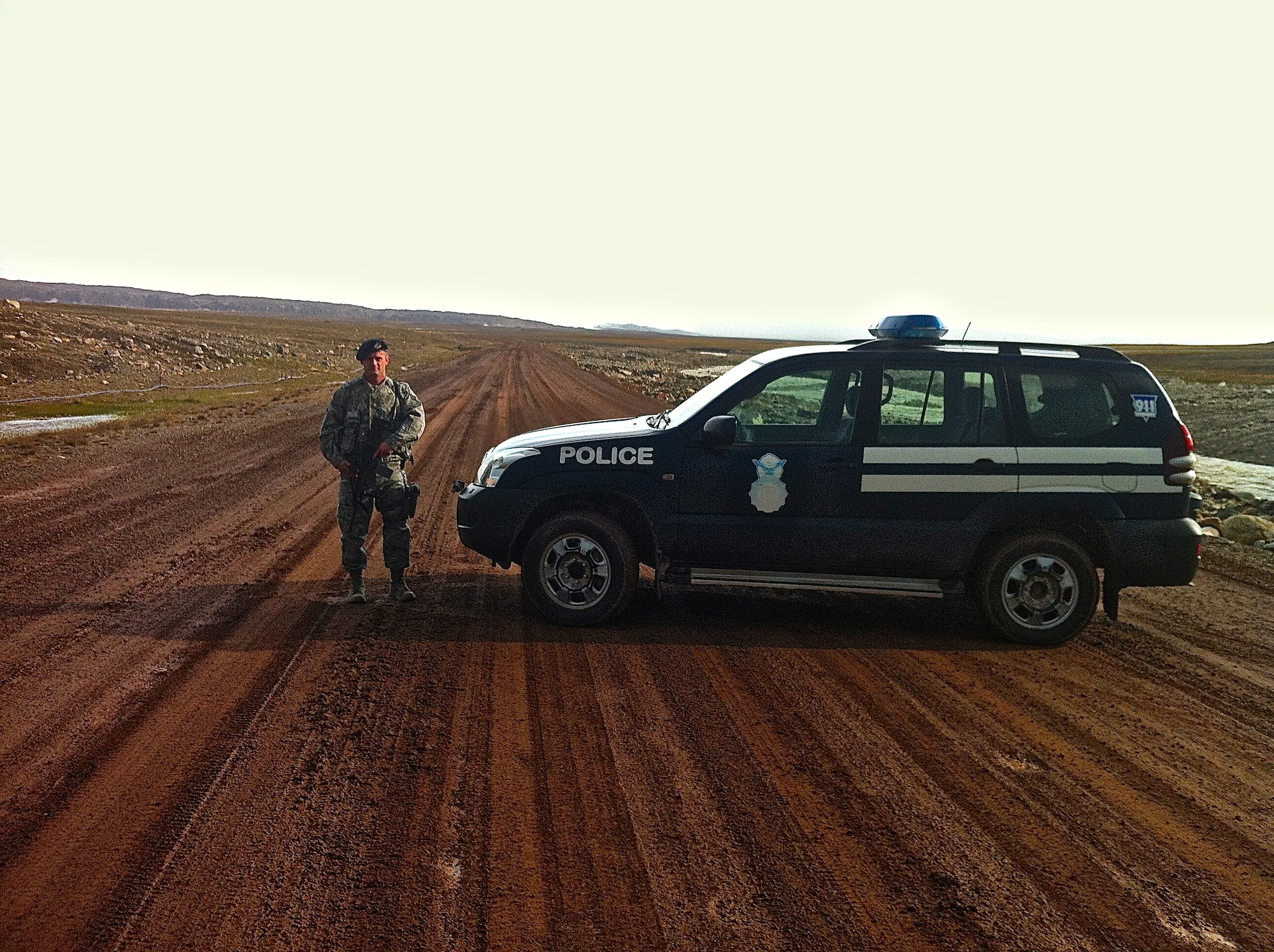 Staff Sgt. Brett Mattmiller, 821st Security Forces Squadron, patrols the main road to Thule Air Base’s missile warning and space surveillance site. The vast terrain the Arctic Defenders secure on a daily basis can be seen in the background. New operations procedures have saved the squadron patrol miles as well as cutting fuel costs. (U.S. Air Force photo/Master Sgt. Clinton Ellis)