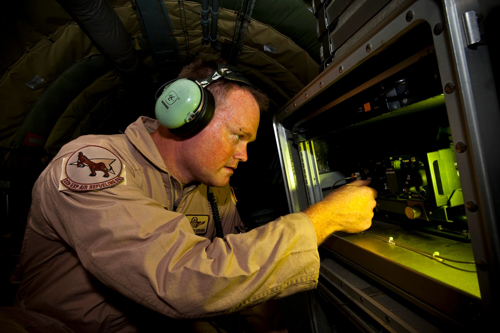 Senior Master Sgt. Keith Werner adjusts a Roll-On Beyond Line of Sight Enhancement, or ROBE, data link system at the Transit Center at Manas, Kyrgyzstan, Aug. 31, 2012. The 22nd Expeditionary Air Refueling Squadron KC-135 crew assisted a stricken fighter aircraft by guiding it through a series of specific maneuvers to reset the on-board flight computers and allowing the pilot to regain effective communications and navigational instruments. Werner is a 22 EARS boom operator deployed out of the 137th Air Refueling Wing, Oklahoma Air National Guard, and is a native of Oklahoma City. (U.S. Air Force photo/Senior Airman Brett Clashman)